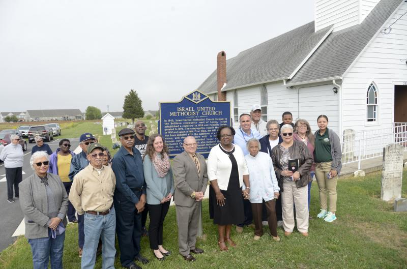 The congregation gathers for a photo. In the crowd are Charmaine Dunning, Sally Duffy, Harvey Morris, Vernon Streett, Carolyn Morris, Paul Selby, Ralph Gooch, Historical Markers Program Coordinator Katie Hall; DPA DIrector Stephen Marz; the Rev. Marjorie Belmont-Burns, Margaret Coursey, Betty Streett, Sandra Neal, Merle Morris, Callee Miller, Sen. Ernie Lopez, Irving Jackson and Jerron Savage.